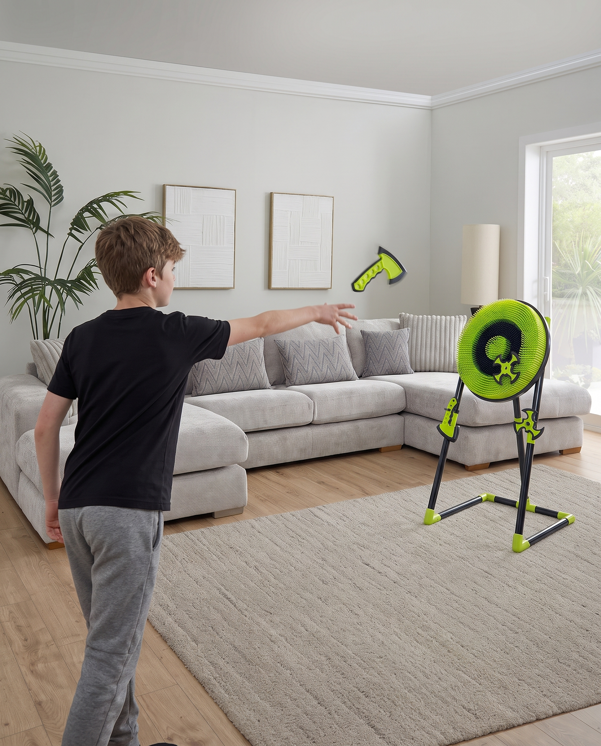 Boy throwing an axe at the NinjaStrike target in a living room